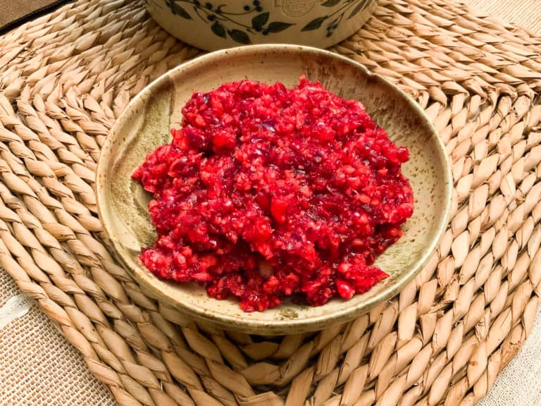 cranberry relish in a pottery bowl on a wicker placement