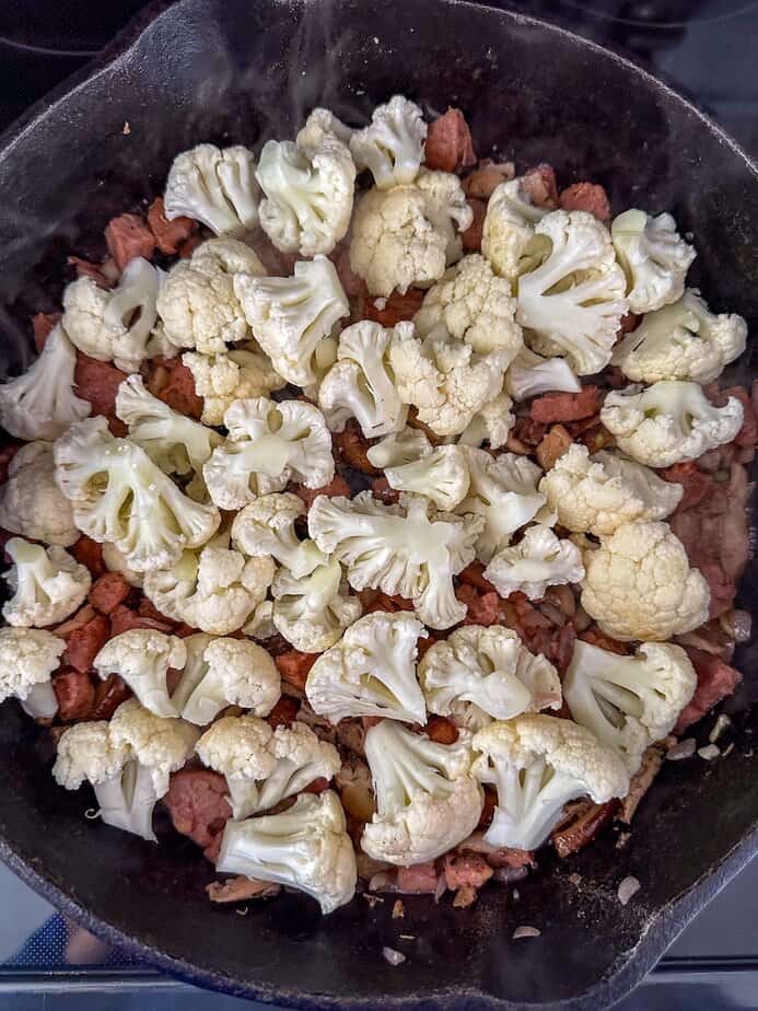 Cauliflower added to skillet.