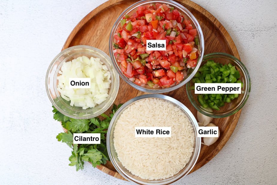Ingredients for instant pot mexican rice; salsa, white rice, green pepper, garlic, cilantro and onion. 