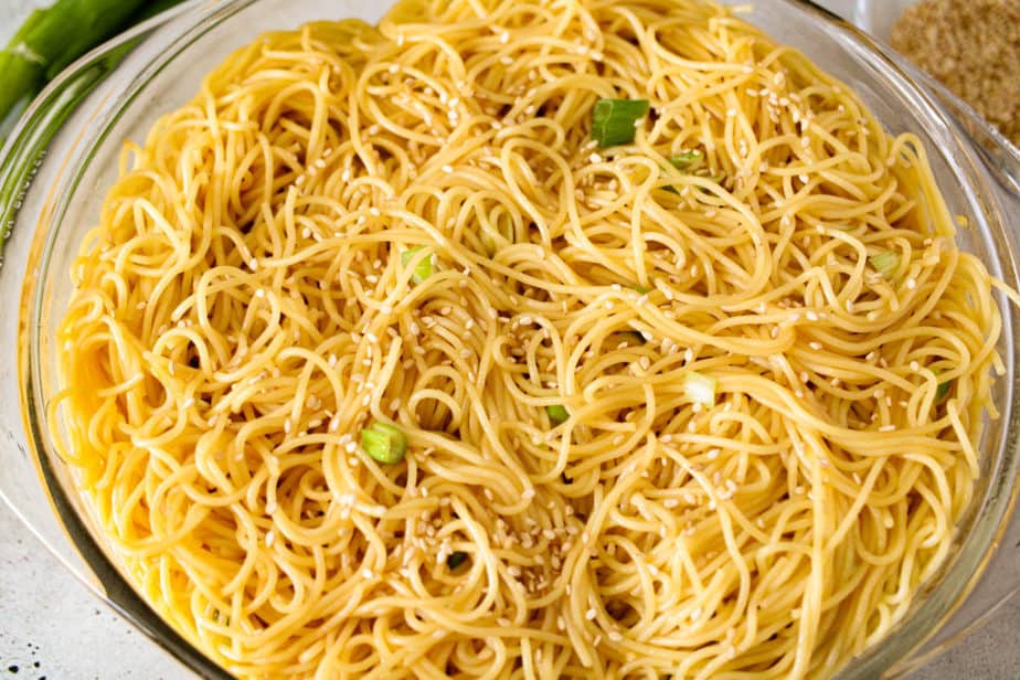 Sesame noodles in a clear glass bowl.