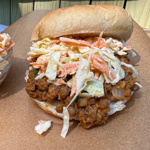 Lentil Sloppy Joe on a bun with Cole slaw on top.