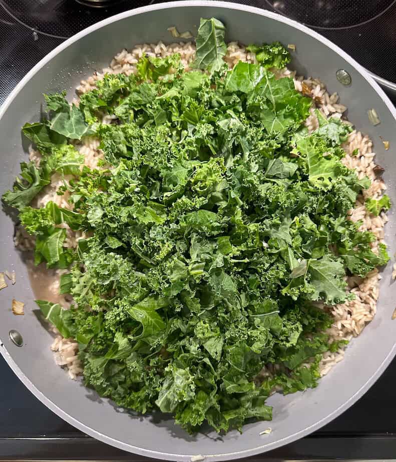 Chopped kale added to pan.