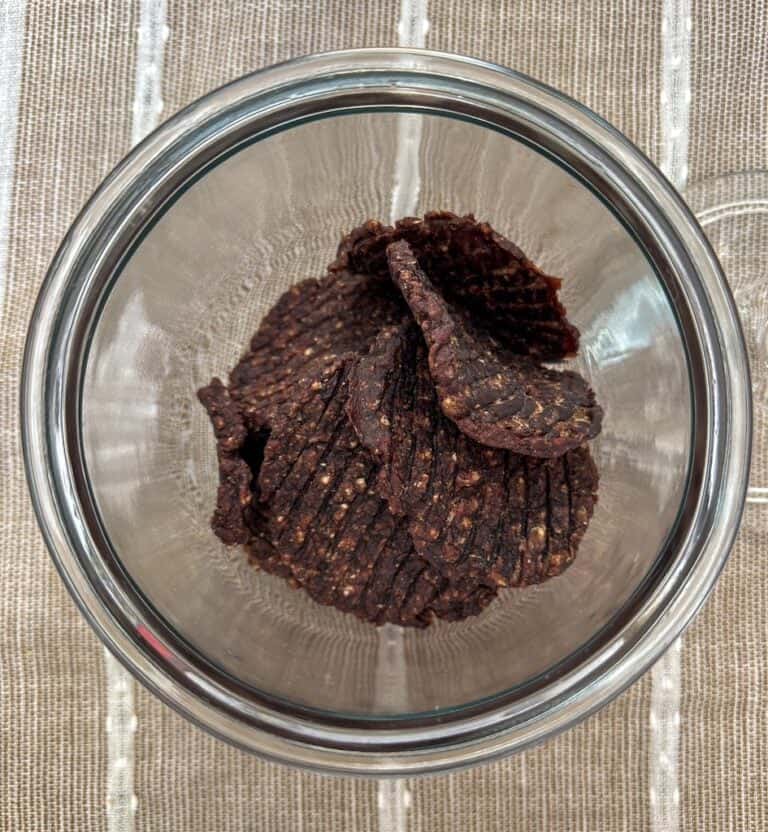 Dehydrated ground beef patties in a glass jar.