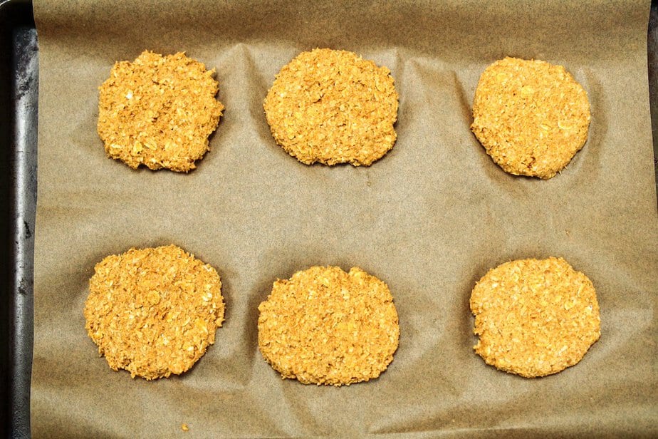 Dog treats on a baking sheet lined with parchment paper before baking.