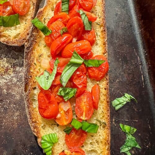 Roasted cherry tomato bruschetta on bread.