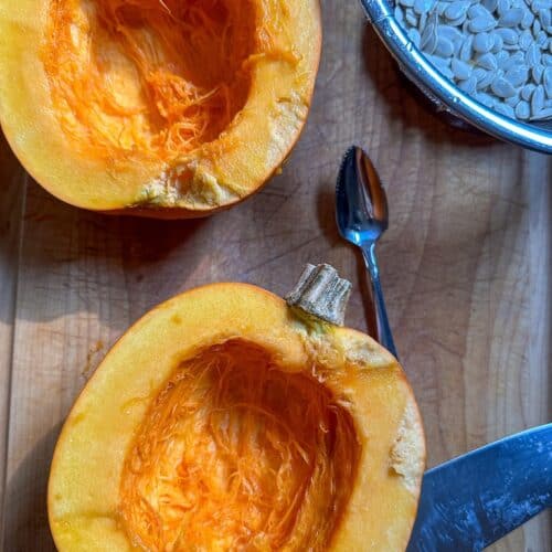 Two pumpkin halves with seeds and membranes removed.