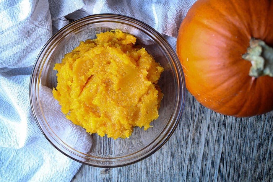 Pureed pumpkin in a clear bowl.
