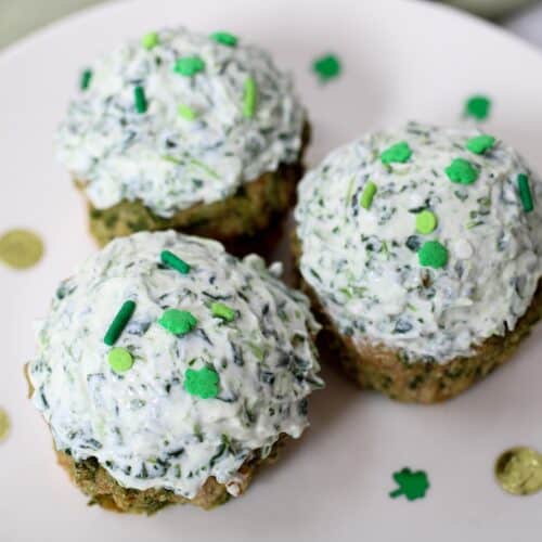 St. Patrick's Day Pupcakes with white and green speckled yogurt frosting.