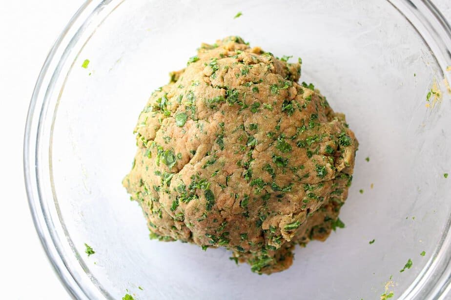 A ball of dog cookie dough with kale.