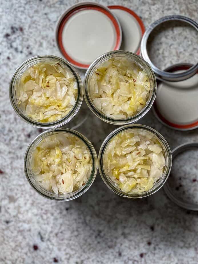 Fermented sauerkrauts in four mason jars.