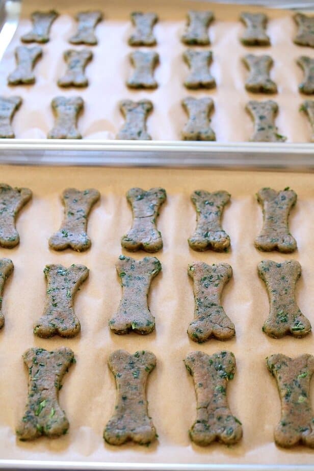 Dog-bone shaped treats on parchment paper.