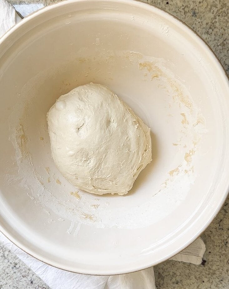 Sourdough ball in a bowl after pull and folds.
