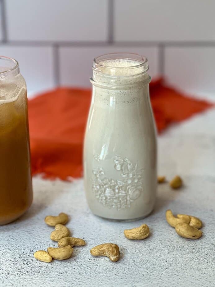 Clear glass container filled with cashew creamer.