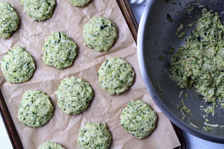 Formed zucchini patties on tray before cooking. 