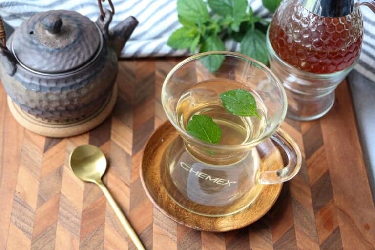 Lemon balm tea in a clear mug.