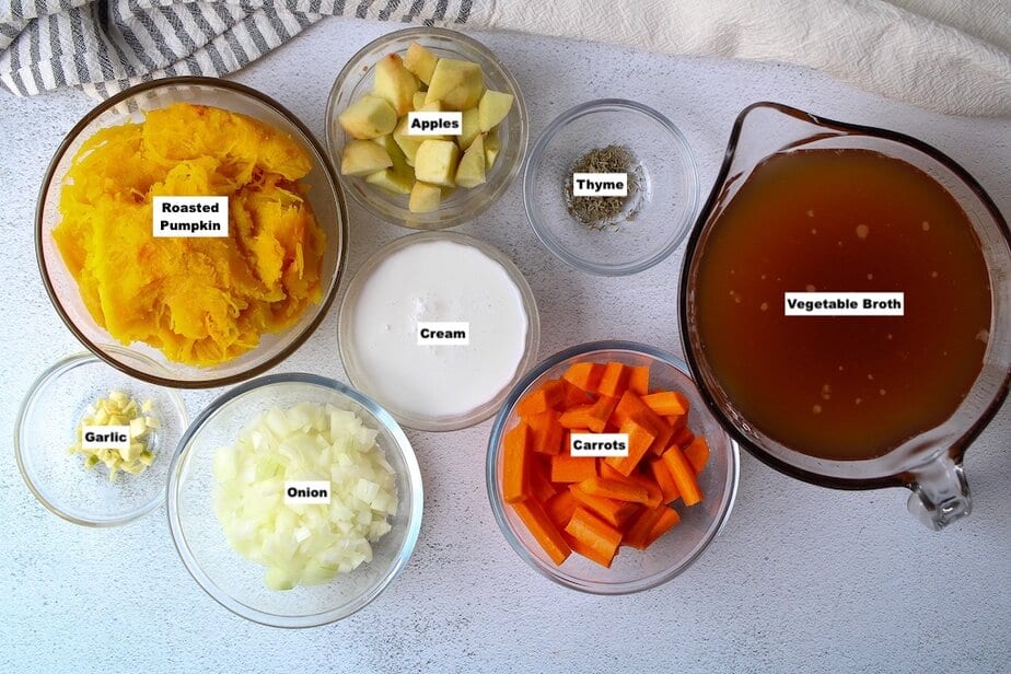 Ingredients for pumpkin soup in clear bowls.