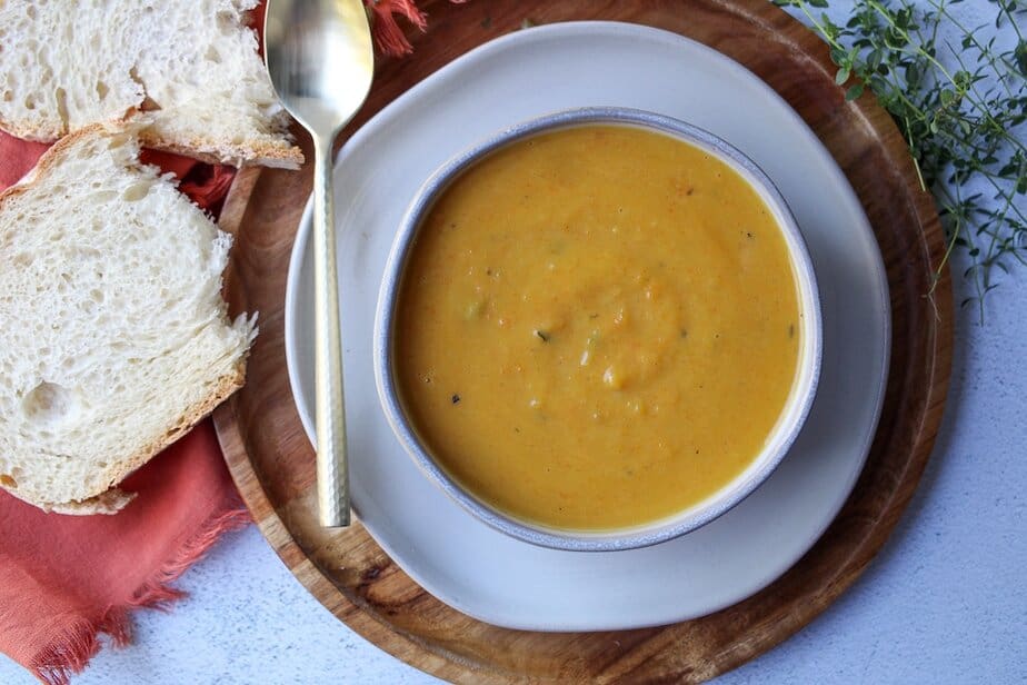Creamy pumpkin and apple soup in a bowl.