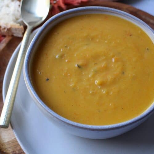 Creamy pumpkin and apple soup in a bowl.
