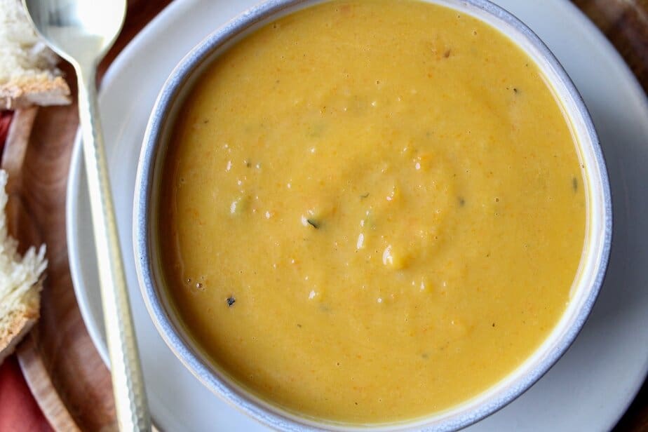 Creamy pumpkin and apple soup in a bowl.