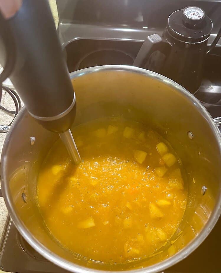 Immersion blender, blending pumpkin soup.