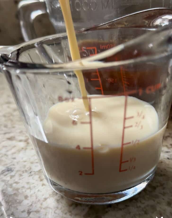 Milk added to measuring cup.