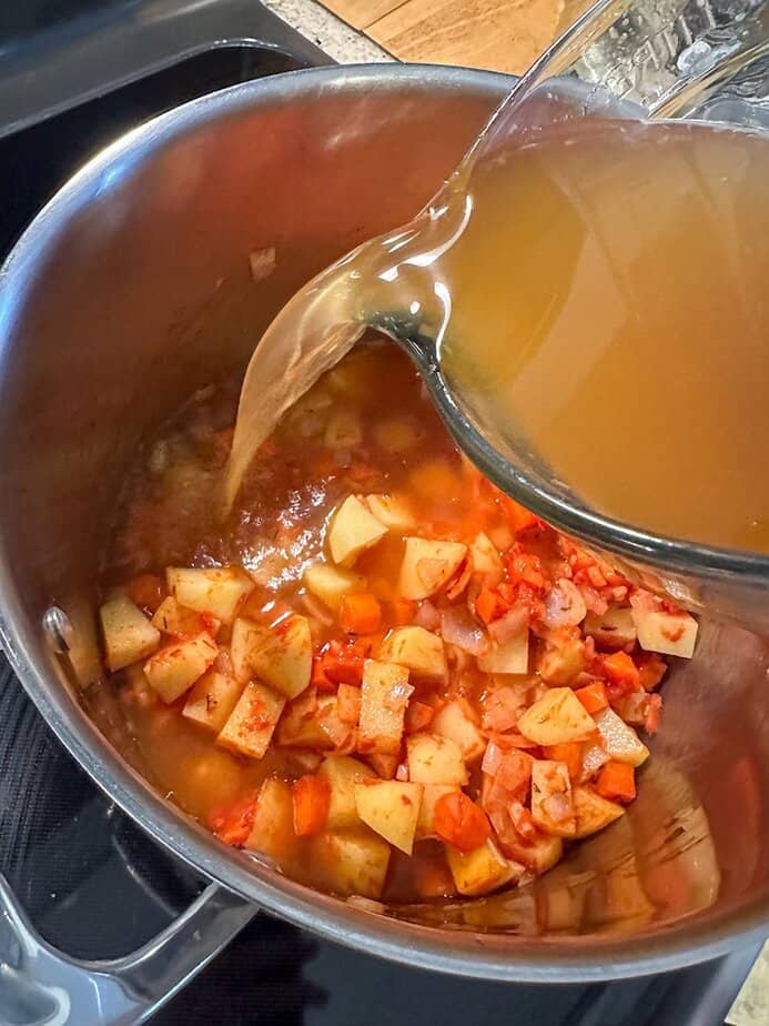 Broth added to vegetables. 