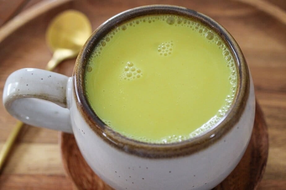 Fresh turmeric latte in a mug.