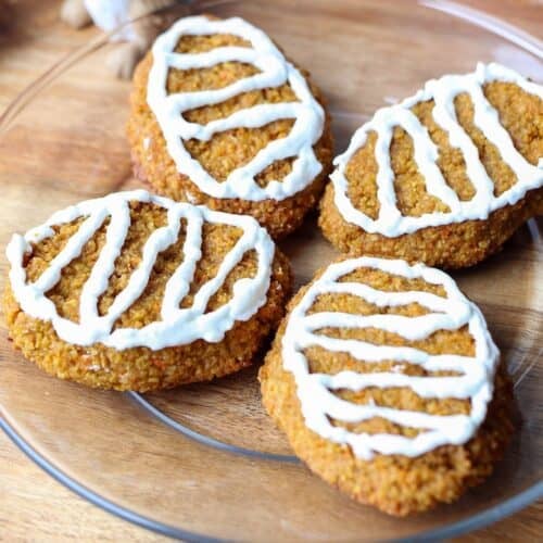 Frosted carrot treats on a plate.