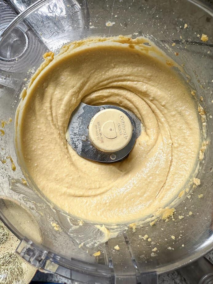 Hummus pureed in a food processor.