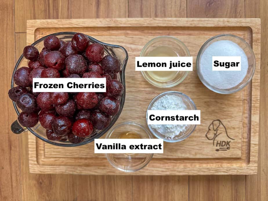 Ingredients for cherry pie filling, labeled in individual bowls.