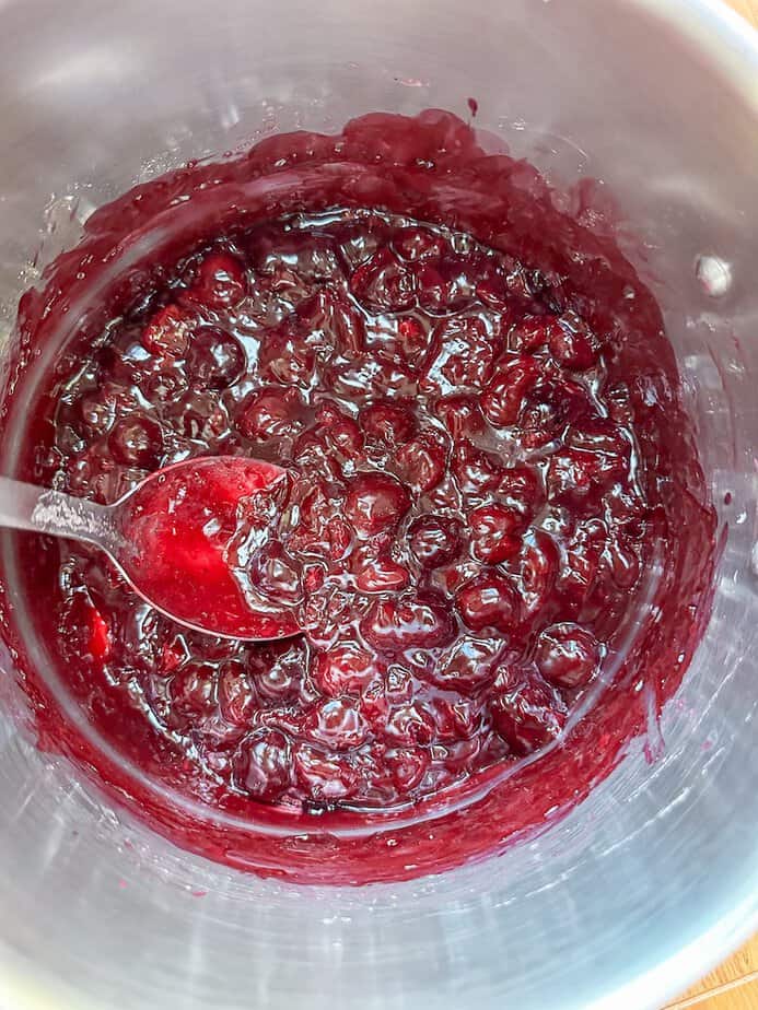 Cooked cherry pie filling in a pot.
