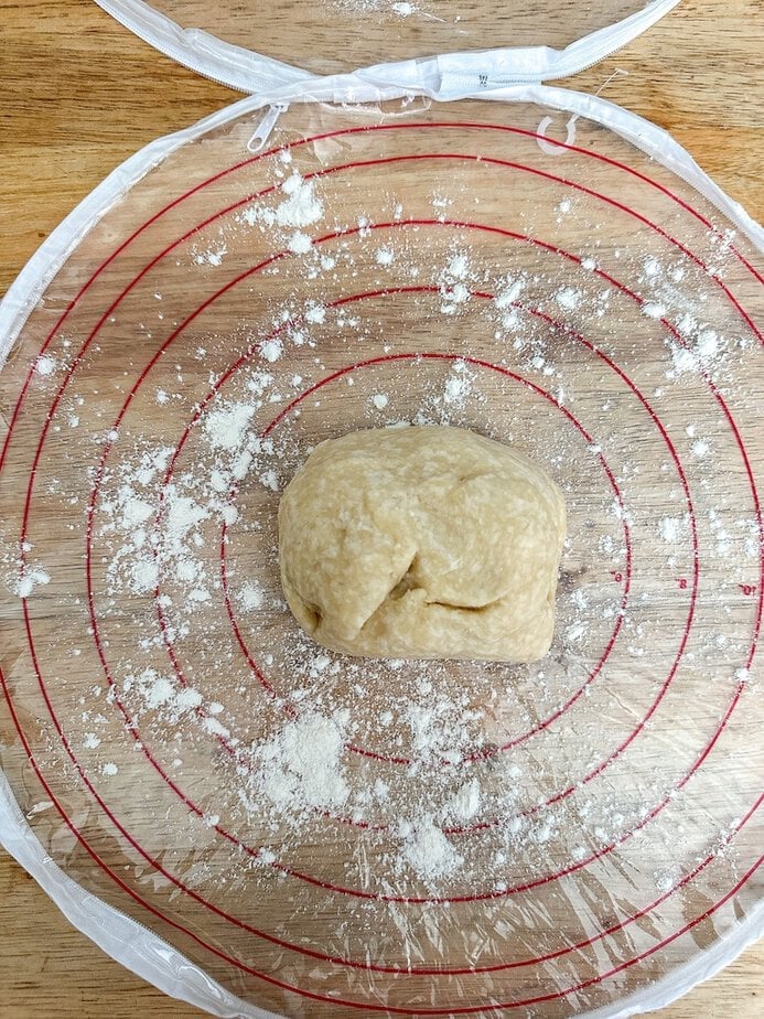Ball of dough in the center of a pie crust bag.