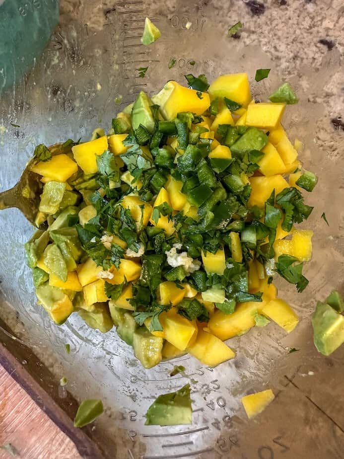 Chopped mango, avocado, and cilantro in a bowl.