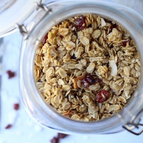 Granola with coconut and cranberries in a jar.