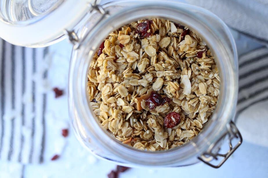 Granola with coconut and cranberries in a jar.