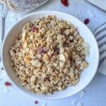 Granola with coconut and cranberries in a bowl.
