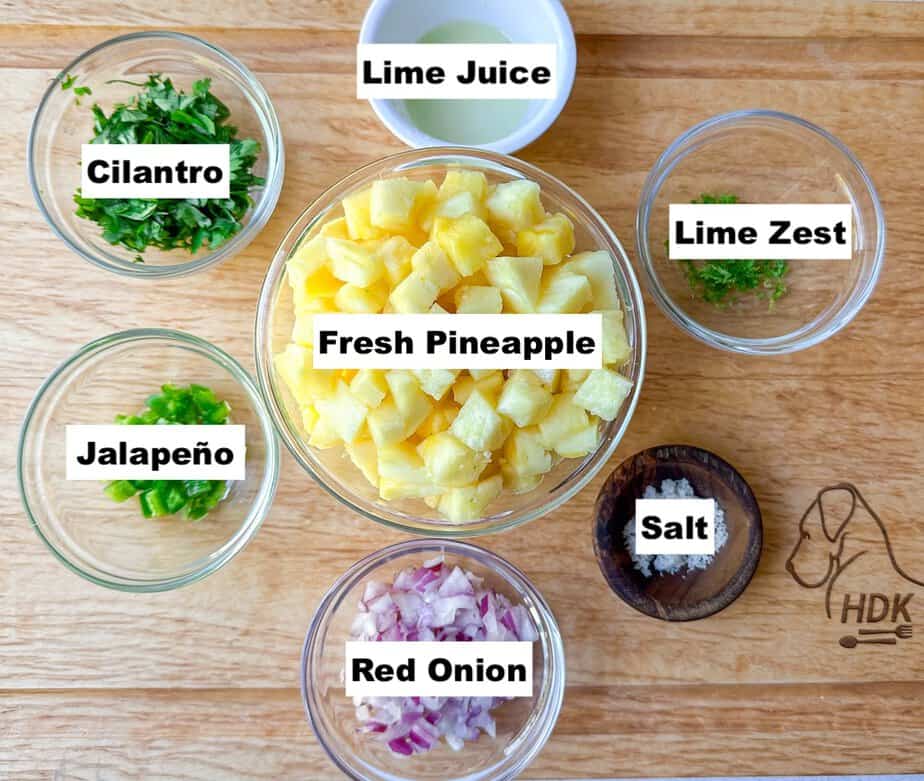 Labeled ingredients for Fresh Pineapple Salsa that are in individual bowls.