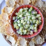 Pineapple Salsa in a festive bowl surround with tortilla chips.