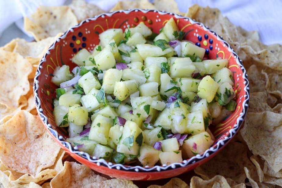 Pineapple Salsa in a festive bowl surround with tortilla chips.