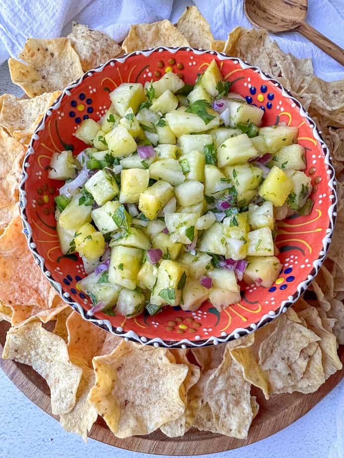Pineapple Salsa in a festive bowl surround with tortilla chips.