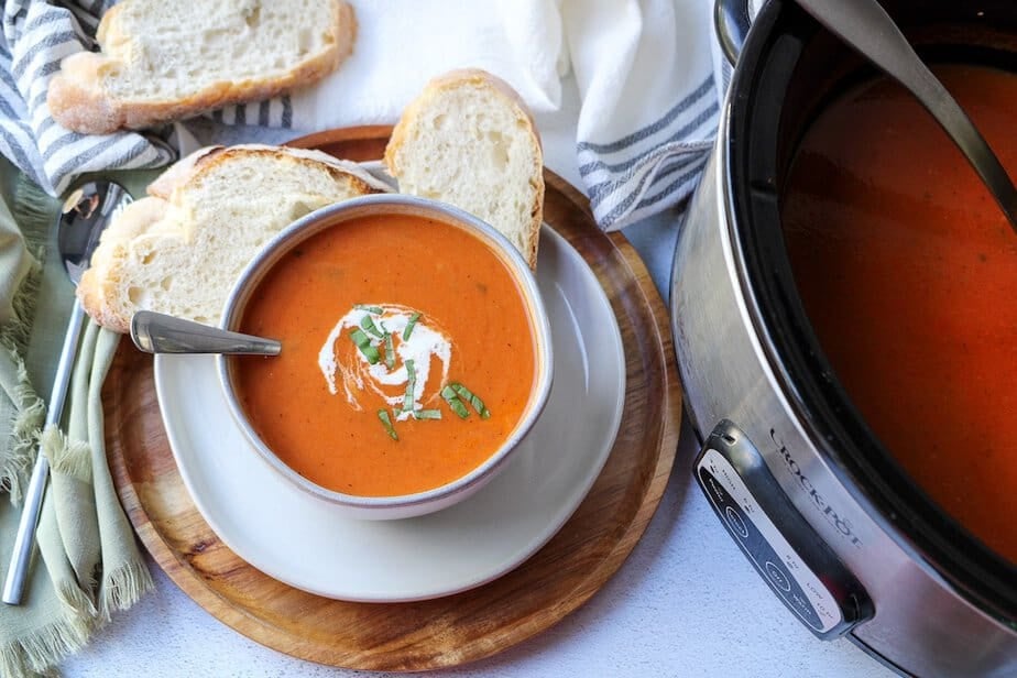 Crockpot tomato soup in a bowl with fresh bread.