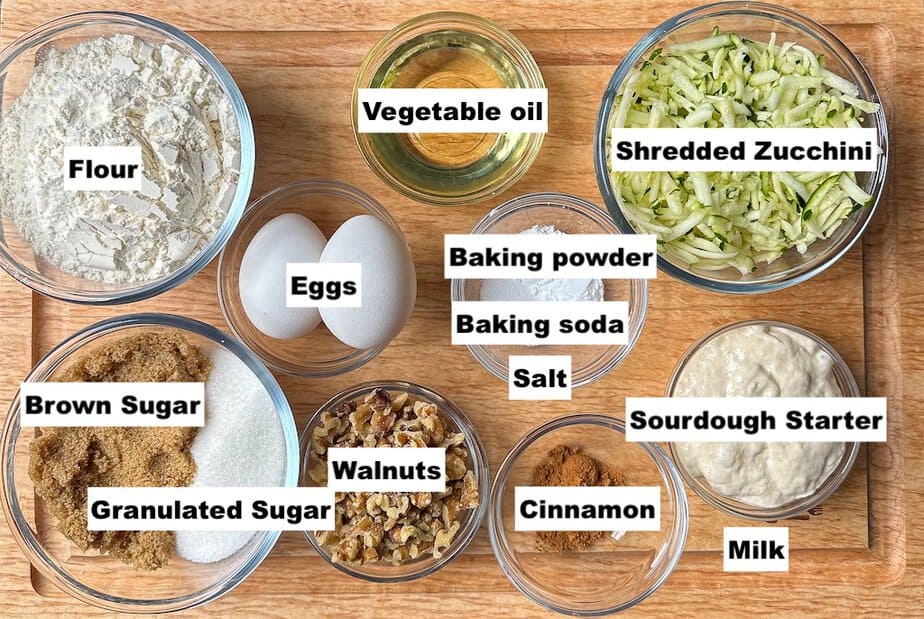 Ingredients for Sourdough Discard Zucchini Muffins in individual bowls that are labeled. 