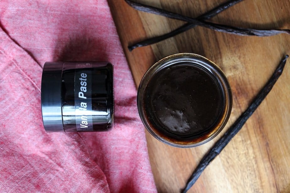 Vanilla bean paste jar with cover off showing paste from the top view. 