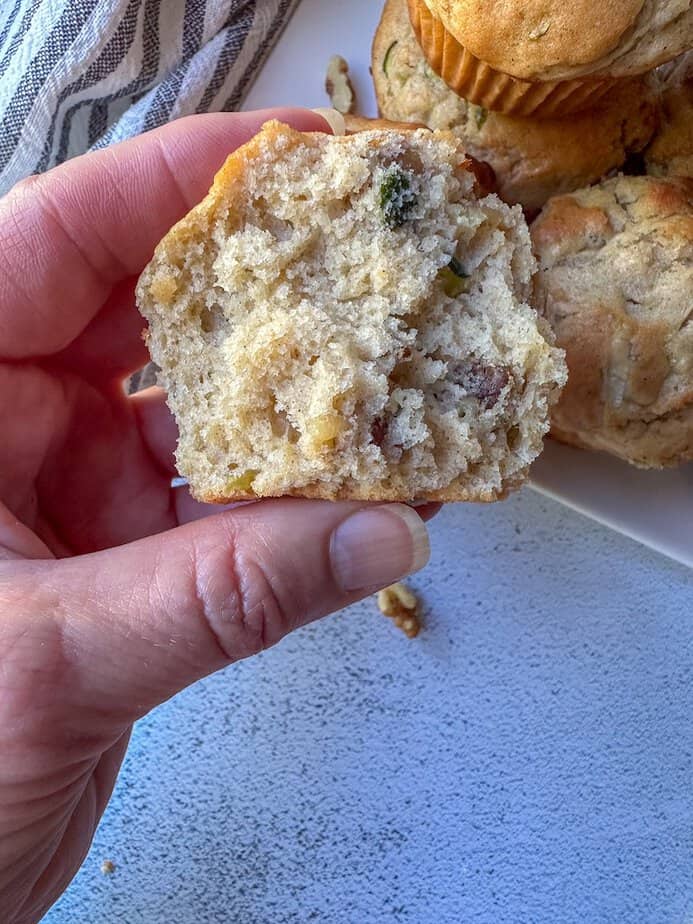 Half of a baked zucchini muffin.