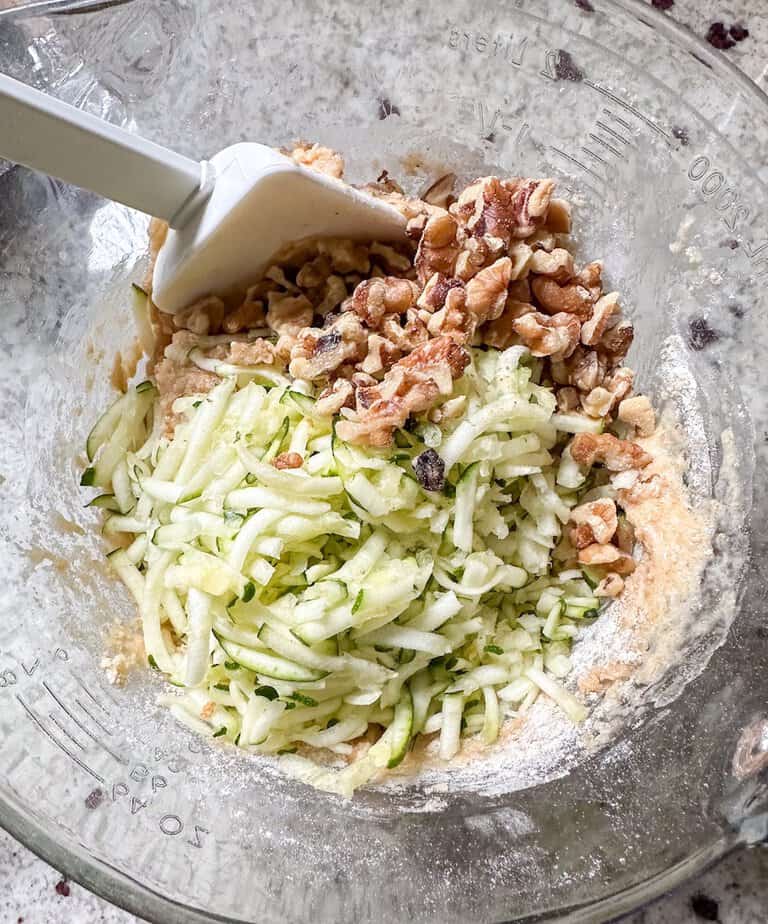 Shredded zucchini and chopped nuts added to muffin batter.